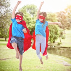 Poster - Composite image of playful siblings disguise as superhero