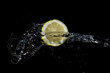 Sliced lemon with water splash on black background