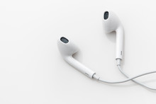 White ear buds on a white background.