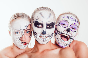 Wall Mural - Three girls with Halloween face art on white background