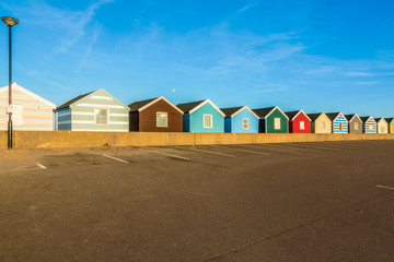 Wall Mural - Row of colourful beach huts against a blue sky in Southwold, Suffolk, UK