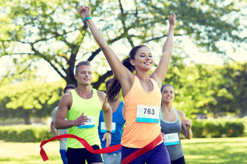 Poster - happy young female runner winning on race finish