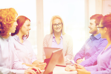 Canvas Print - smiling team with laptop and table pc computers