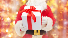 Man In Costume Of Santa Claus With Gift Box