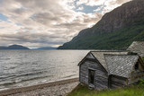 Fototapeta Góry - Old norwegian traditional house near fjord