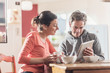 © jackfrog - Nice couple using a tablet while having breakfast in the kitchen