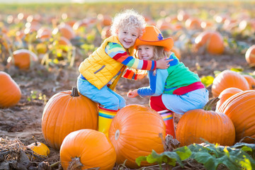 kids picking pumpkins on halloween pumpkin patch