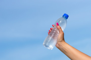  Woman hand holding water bottle outdoors