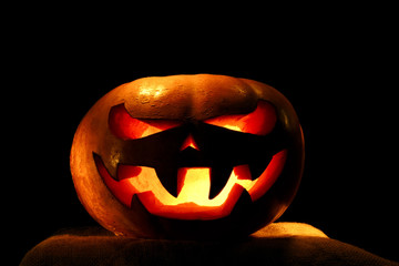 very scary Halloween pumpkin isolated on black background with i