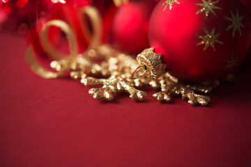 Wall Mural - golden and red christmas ornaments on red background with copy space. merry christmas card. winter h