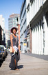 Portrait of fashionable woman walking on city street