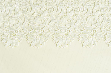Wall Mural - White embroidered lace on white wood