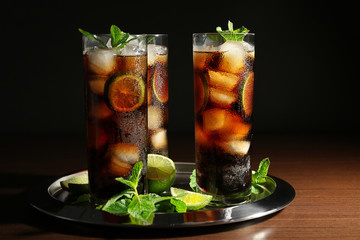 Poster - Metal tray with cuba libre cocktails, lime and mint on wooden table