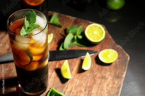 Kitchen board with cuba libre cocktail, knife, mint and lime Canvas Print