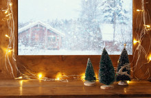 Window Sill With Christmas Lights In Front Of Winter Landscape