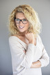 © goodluz - Portrait of attractive blond woman with eyeglasses, isolated