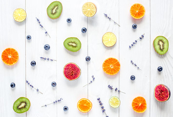 Colorful pattern made of fruits on white wood