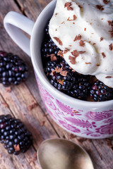 Wall Mural - Cup of fresh natural blackberries with whipped cream