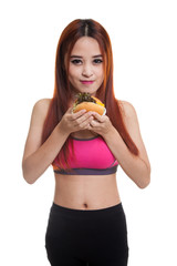 Wall Mural - Beautiful Asian healthy girl enjoy eating  hamburger.