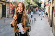 Happy Smiling Blonde Girl With Popcorn In The Street
