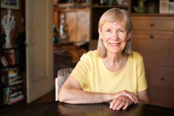 Wall Mural - Confident mature woman seated at table