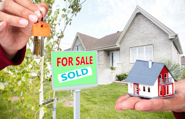 Canvas Print - Hand with a little house and keys.