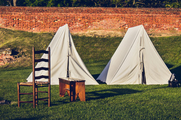 private revolutionary war camp with tents and chair