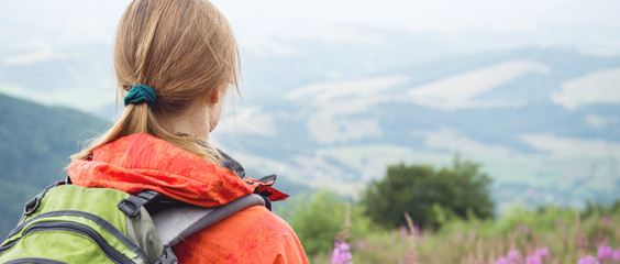 Wall Mural - young woman hiking in the mountains