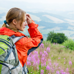 Wall Mural - young woman hiking in the mountains