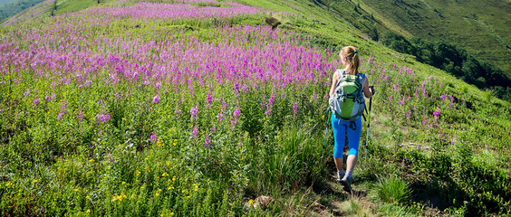 Wall Mural - young woman hiking in the mountains