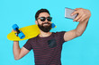 © kegfire - young handsome bearded hipster man makes selfie