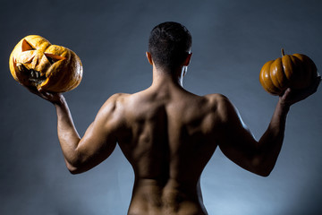 muscular man with pumpkins