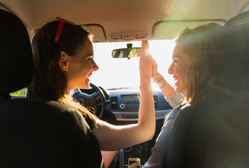 Wall Mural - happy teenage girls or women driving in car