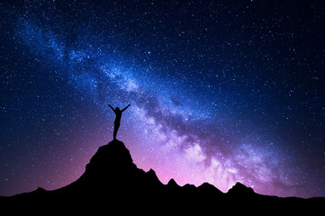 landscape with milky way. colorful night sky with stars and silhouette of a standing happy woman wit