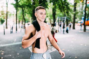 Wall Mural - Outdoor portrait of healthy handsome active man with fit muscular body, sports and fitness concept