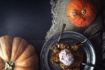 Wall Mural - Pumpkin dump cake with ice cream on the metal plate on the stone table horizontal