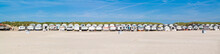 Row Of Beach Houses Or Huts On IJmuiden Beach At North Sea Coast In Netherlands