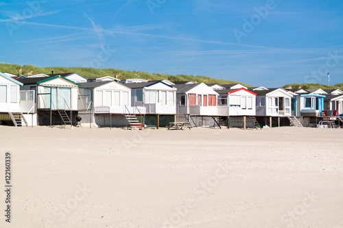 Fotografie, Obraz Row of beach houses or huts on IJmuiden beach at North Sea coast in Netherlands