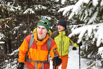 Wall Mural - Two hikers in winter forest