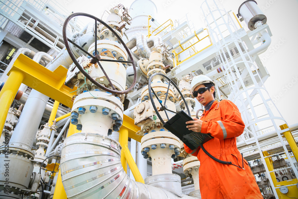 operator recording operation of oil and gas process at oil and rig plant,  offshore oil and