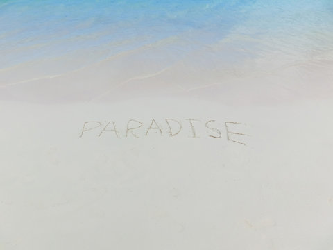 Inscription on the sand Paradise