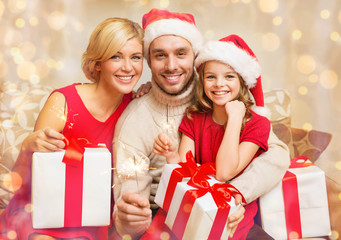 Poster - smiling family holding gift boxes and sparkles