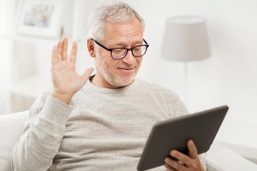 Poster - senior man having video call on tablet pc at home