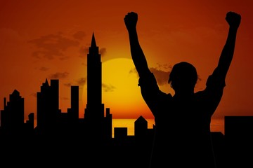 Poster - silhouette of cheering person with city and sunset background