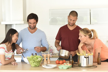 Wall Mural - Friends having fun cooking meal together