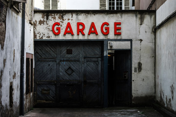 Old abandoned garage with red sign