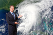 Television meteorologist weatherman forcasting with hurricane typhoon cyclone image in background