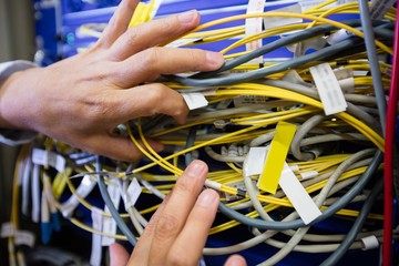 Aufkleber - Technician checking cables in a rack mounted server