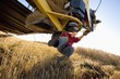 © Designpics - Woman working with equipment for harvesting wheat, Alberta, Canada