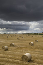 Dark Storm Clouds Over A Field With Hay Bales, South Shields, England